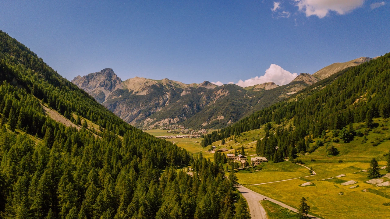 Aerial view of a lush green alpine valley in the Savoie region of the French Alps in summer